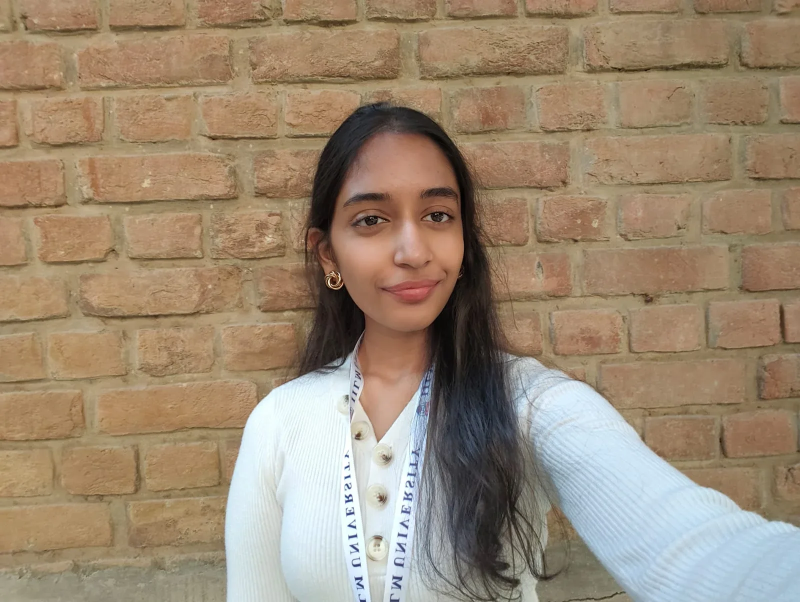 A selfie against a brick wall