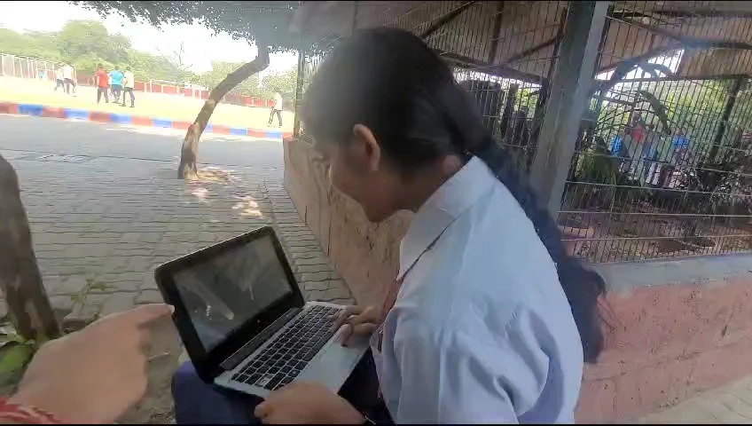 Khushi working on a laptop during school